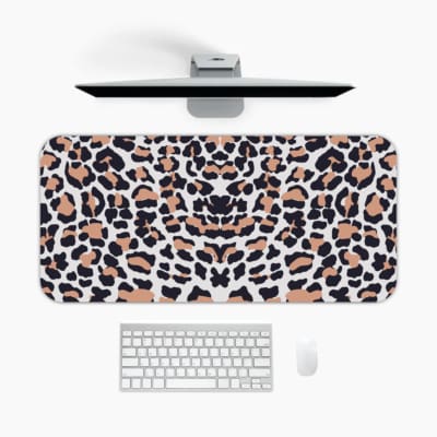 Infidu White Desk Pad with Bold Leopard Print Design featuring black and brown spots on a white background. A desk pad under the computer