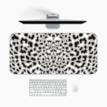 Infidu White Desk Pad with black leopard print spots on a white background, featuring a bold and untamed animal print design. A desk pad under the computer