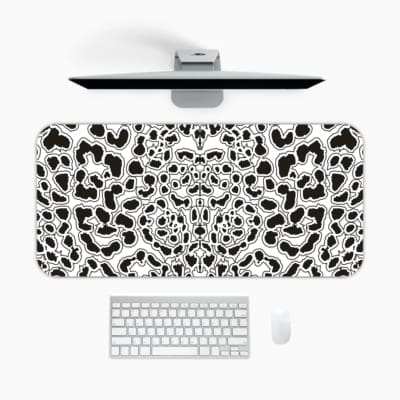 Infidu White Desk Pad with black leopard print spots on a white background, featuring a bold and untamed animal print design. A desk pad under the computer