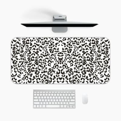 Infidu White Leopard Print Desk Pad features black spots on a white background, creating a classic and stylish leopard print design. A desk pad under the computer