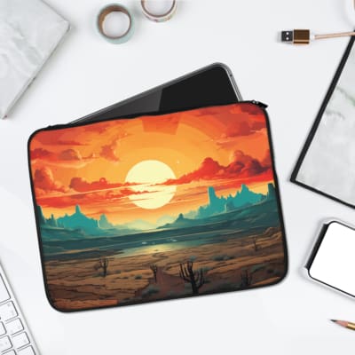 Desert sunset laptop sleeve with warm orange sky, teal mountains, and scattered cacti for a bold and artistic design. laptop sleeve kept on a plain white background