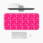 Pink and white polka dot desk pad with a classic pattern design. A desk pad under the computer