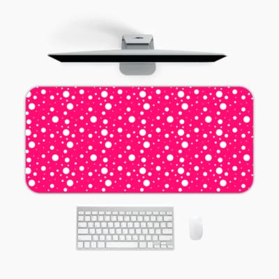 Pink and white polka dot desk pad with a classic pattern design. A desk pad under the computer