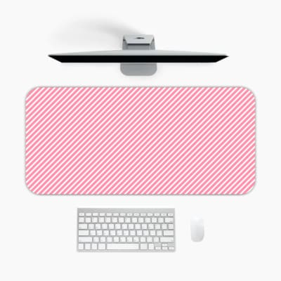 Light pink diagonal striped desk pad with a soft and pastel design, featuring thin pink stripes on a light background. A desk pad under the computer