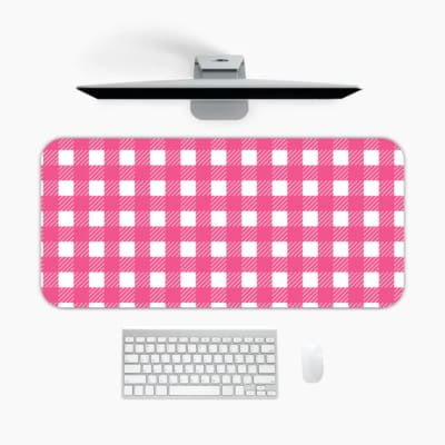 Pink and white checkered desk pad with a grid-like pattern on a white background. A desk pad under the computer