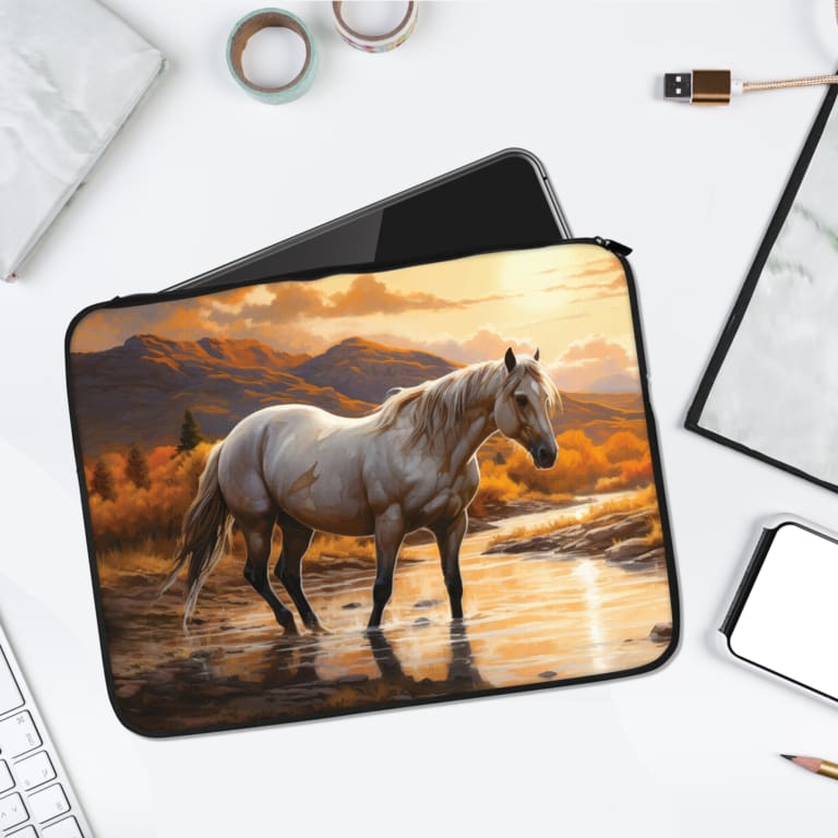 Gray Horse Laptop Sleeve with sunset and mountain background, featuring warm tones of orange, brown, and gray. laptop sleeve kept on a plain white background