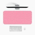 Light pink and white polka dot desk pad with a classic pattern design. A desk pad under the computer