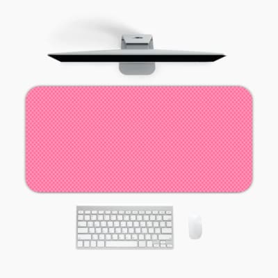 Bright pink desk pad with subtle dotted design, adding a textured look to a simple background. A desk pad under the computer