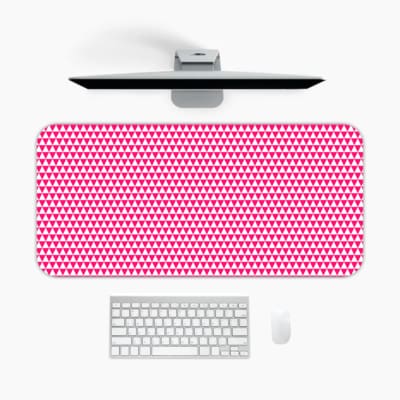 Pink desk pad with a pattern of small, evenly spaced triangles. A desk pad under the computer