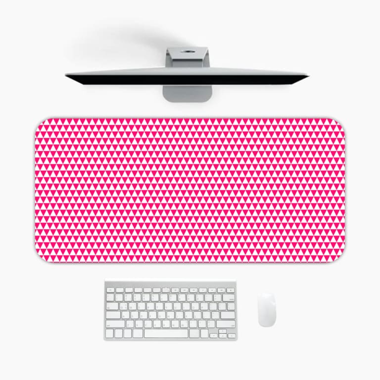 Pink desk pad with a pattern of small, evenly spaced triangles. A desk pad under the computer