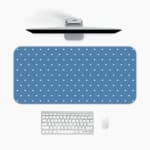 Blue and white polka dot desk pad with a classic pattern design. A desk pad under the computer