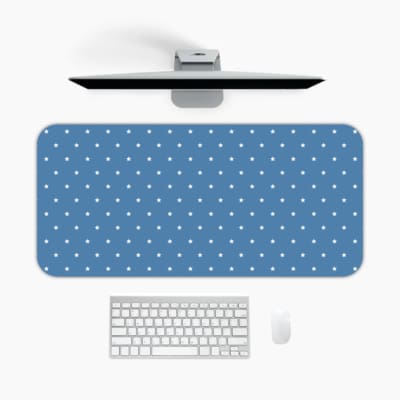 Blue and white polka dot desk pad with a classic pattern design. A desk pad under the computer