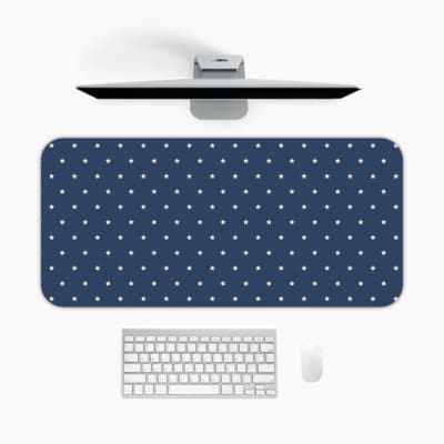 Blue and white polka dot desk pad with a classic pattern design. A desk pad under the computer