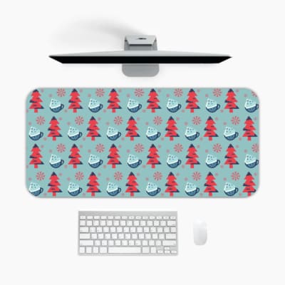 Infidu desk pad with red Christmas trees and blue teacups on a light blue background, creating a festive and cheerful design. A desk pad under the computer