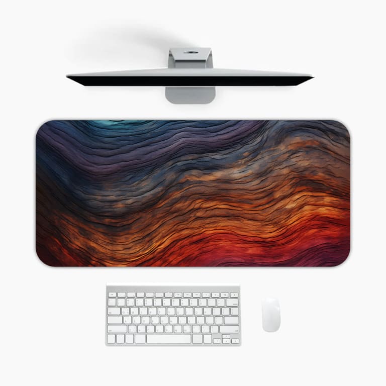 Abstract desk mat with flowing blue-to-red waves, smooth texture, and vibrant colors. A desk pad under the computer