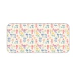 Desk pad with a light background featuring a colorful pattern of floral and abstract shapes in blue, pink, yellow, and green. Desk Pad kept on a plain white background
