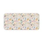 Desk pad with soft pastel floral design in pink, blue, and beige on a light cream background. Desk Pad kept on a plain white background