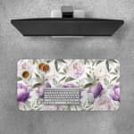 Infidu desk pad with purple and white flowers and green leaves on a white background. Desk Pad with Keyboard and Mouse on top of the desk pad