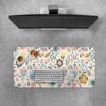Infidu desk pad with soft pastel floral design on a light pink background, featuring delicate light blue, pink, and beige flowers. Desk Pad with Keyboard and Mouse on top of the desk pad