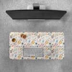 Desk pad with soft pastel floral design in pink, blue, and beige on a light cream background.Desk Pad with Keyboard and Mouse on top of the desk pad