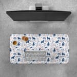 Desk pad with playful blue and dark blue bear patterns on a white background. Desk Pad with Keyboard and Mouse on top of the desk pad