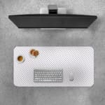 Desk pad with a white background and light gray diagonal stripes. Desk Pad with Keyboard and Mouse on top of the desk pad