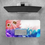 Desk pad with a gradient color design transitioning from red to blue and green, featuring abstract wavy patterns. Desk Pad with Keyboard and Mouse on top of the desk pad