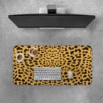 Infidu Leopard Print Desk Pad features a leopard print pattern with a tan background and black spots, resembling natural leopard fur. Desk Pad with Keyboard and Mouse on top of the desk pad