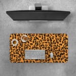 Infidu Leopard Print Design Desk Pad with black spots on a yellow background, simulating a leopard's natural fur. Desk Pad with Keyboard and Mouse on top of the desk pad