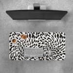 Infidu Bold Black and White Abstract Print Desk Pad with black abstract shapes on a white background, resembling animal print. Desk Pad with Keyboard and Mouse on top of the desk pad