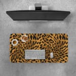 Infidu Leopard Print Desk Pad features a leopard print pattern with a brown background and black spots, resembling natural leopard fur. Desk Pad with Keyboard and Mouse on top of the desk pad
