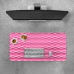 Pink desk pad with a pattern of small, evenly spaced triangles. Desk Pad with Keyboard and Mouse on top of the desk pad