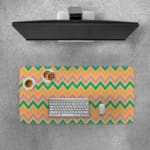 Infidu Teal and Purple Chevron Desk Pad with Peach Background featuring a zigzag pattern in vibrant teal and purple tones. Desk Pad with Keyboard and Mouse on top of the desk pad