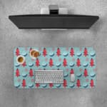 Infidu desk pad with red Christmas trees and blue teacups on a light blue background, creating a festive and cheerful design. Desk Pad with Keyboard and Mouse on top of the desk pad