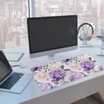 Infidu desk pad with colorful floral design on white background. Features large yellow and purple flowers with green and grayish leaves. Desk Pad with Keyboard and Mouse on top of the desk pad