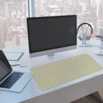 Infidu Minimalist Desk Mat with light gray and white tones, showcasing a sleek and modern design. A computer and laptop are next to the desk pad
