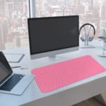 Infidu Pink Desk Mat with White Polka Dots A computer and laptop are next to the desk pad