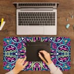 Infidu Colorful Geometric Pattern Desk Pad with pink, blue, yellow, and black geometric shapes on a soft yellow background. A writing pad on top of the desk pad