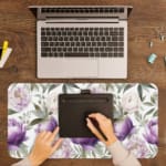 Infidu desk pad with purple and white flowers and green leaves on a white background. A writing pad on top of the desk pad