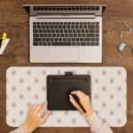 Light pink desk pad with small star design, perfect for adding charm to your workspace. A writing pad on top of the desk pad