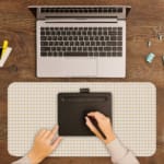 Infidu Beige Desk Pad with light orange checkered grid design, minimalistic and modern. A writing pad on top of the desk pad