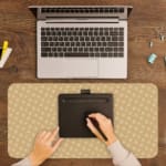 Infidu Light Beige Desk Pad with a small white dot pattern, creating a subtle and minimalist design for a clean desk setup. A writing pad on top of the desk pad