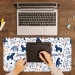 Infidu Blue and White Animal Shapes Playful Design Desk Pad with abstract shapes on a light background. A writing pad on top of the desk pad