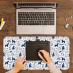 Desk pad with playful blue and dark blue bear patterns on a white background. A writing pad on top of the desk pad