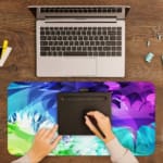 Infidu Watercolor Gradient Abstract Desk Pad with vibrant blue, purple, green, and white colors in a gradient pattern. A writing pad on top of the desk pad