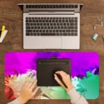 Infidu Dreamy Purple and Green Abstract Desk Pad with soft, blended colors in purple, green, and pink, featuring a smooth, dreamy design. A writing pad on top of the desk pad