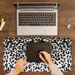 Infidu White Leopard Print Desk Pad features black spots on a white background, creating a classic and stylish leopard print design A writing pad on top of the desk pad