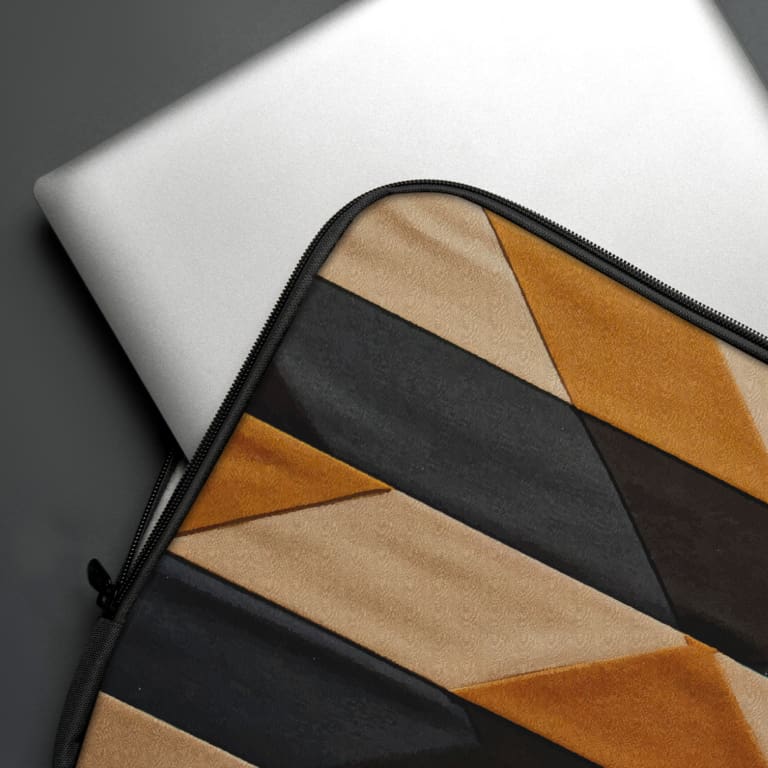 Infidu Geometric Triangle Laptop Sleeve featuring bold triangular and striped patterns in orange, black, and beige colors. The laptop sleeve covers the laptop
