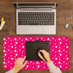 Pink and white polka dot desk pad with a classic pattern design. A writing pad on top of the desk pad