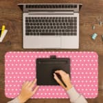Light pink and white polka dot desk pad with a classic pattern design. A writing pad on top of the desk pad